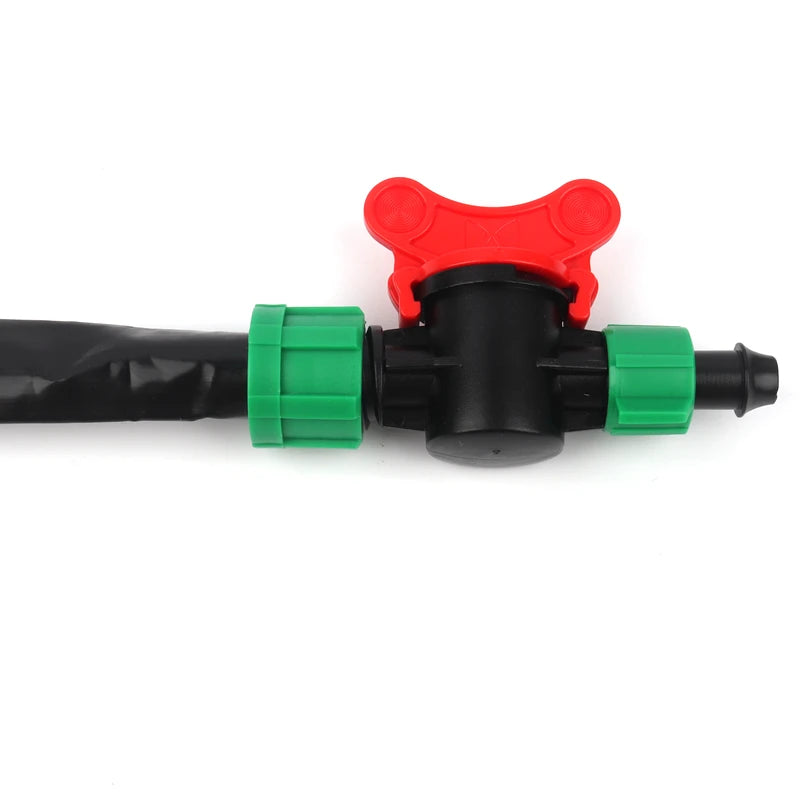 Plumbing valve with black hose, red and green connectors on a white background