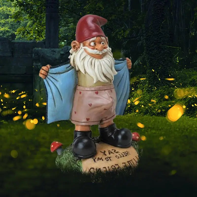 Gnome figurine with a blue cape in a garden setting