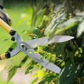 metal cutting shears cutting trees