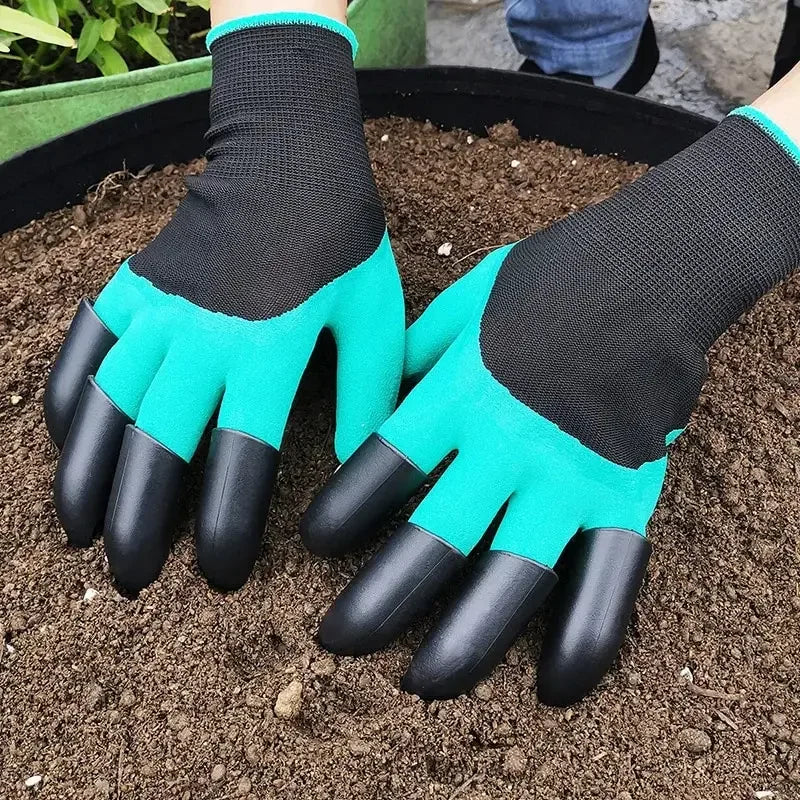 Gardening gloves with clawed fingers on a soil background