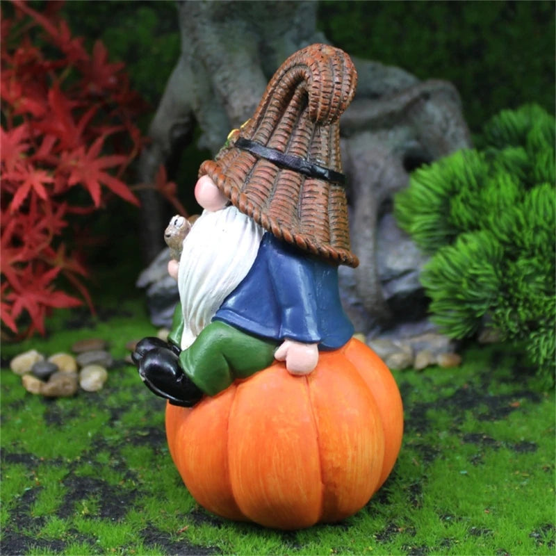 Gnome figurine with a basket on a pumpkin in a garden setting