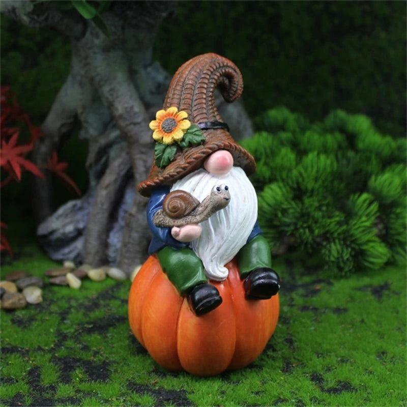 Gnome figurine on a pumpkin with a pointed hat in a garden setting