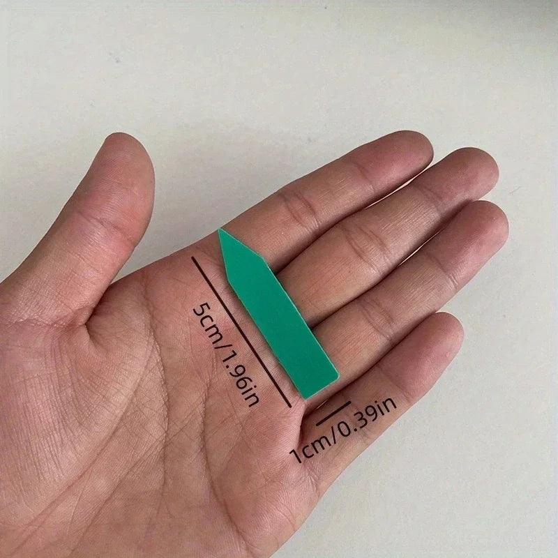 Teal measuring tape on a hand with measurements indicated