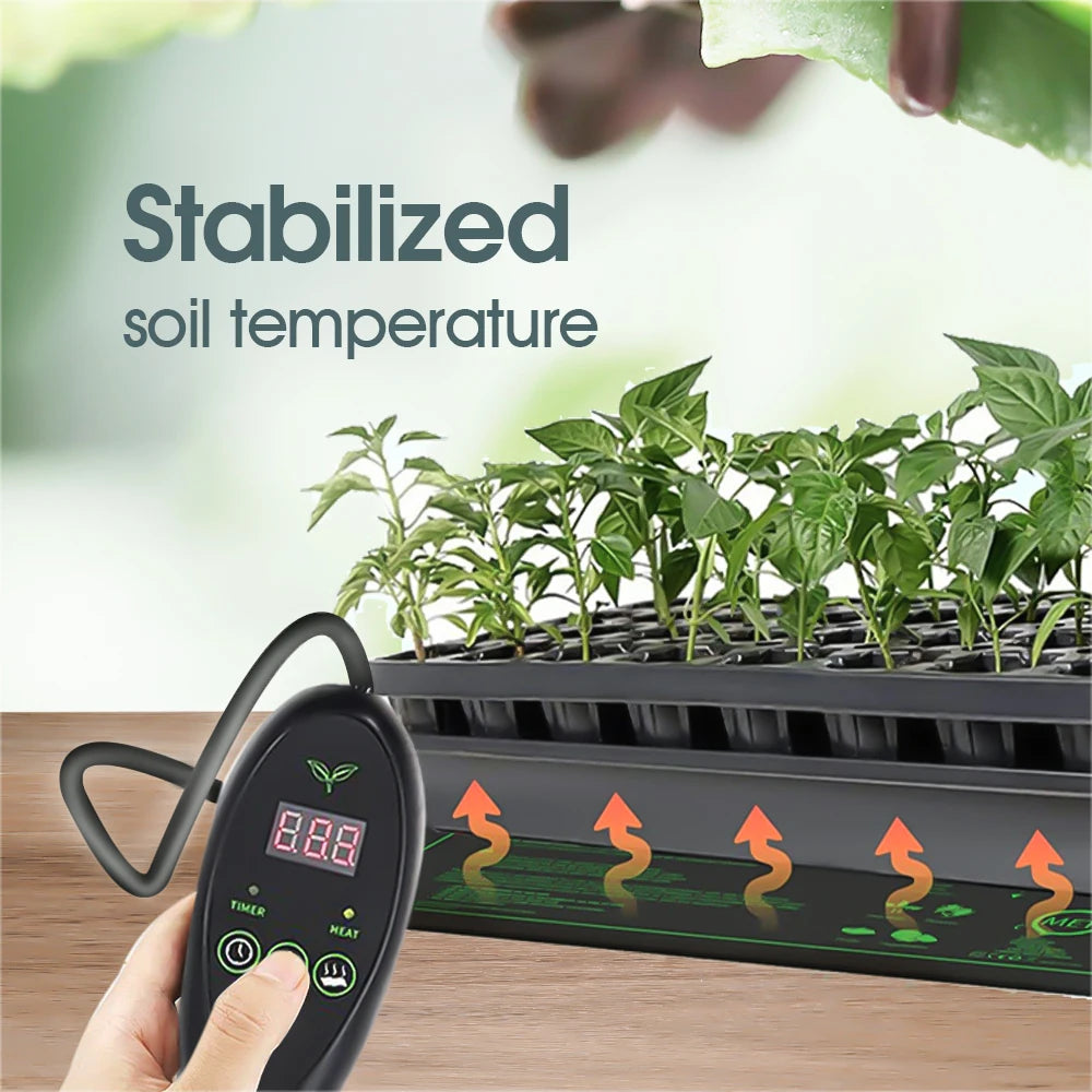 A black electronic soil temperature controller with a digital display and temperature arrows is shown in a hand, with a tray of green seedlings in a grow kit in the background and the text 'Stabilized soil temperature' on a blurred light background.