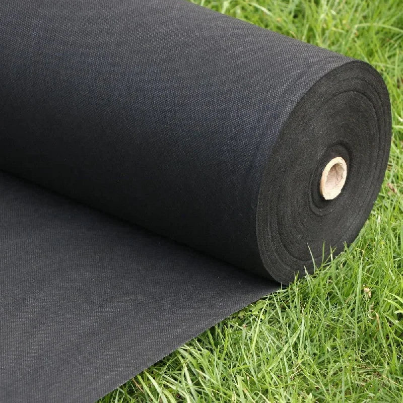 Roll of black weed barrier fabric on grass